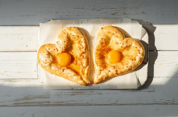 Two khachapuri in the shape of a heart dinner in a Georgian restaurant for two on Valentine's Day