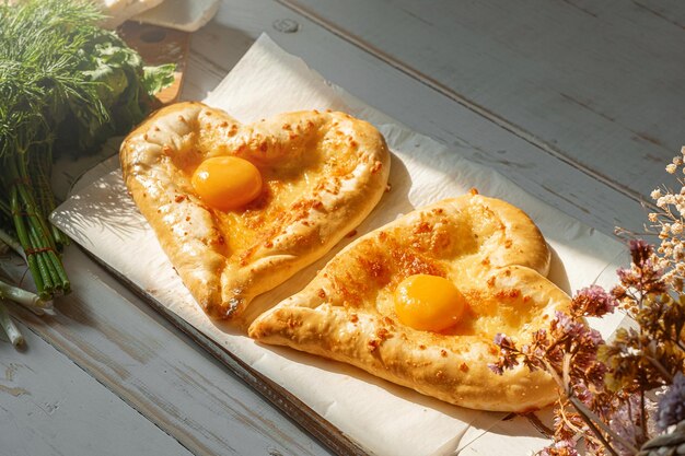 Two khachapuri in the shape of a heart dinner in a Georgian restaurant for two on Valentine's Day