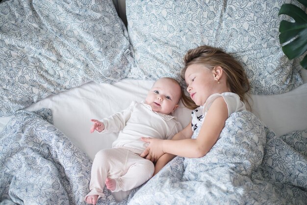 two kids playing in bed