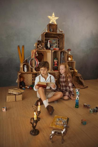 Two kids playing at home during winter holidays