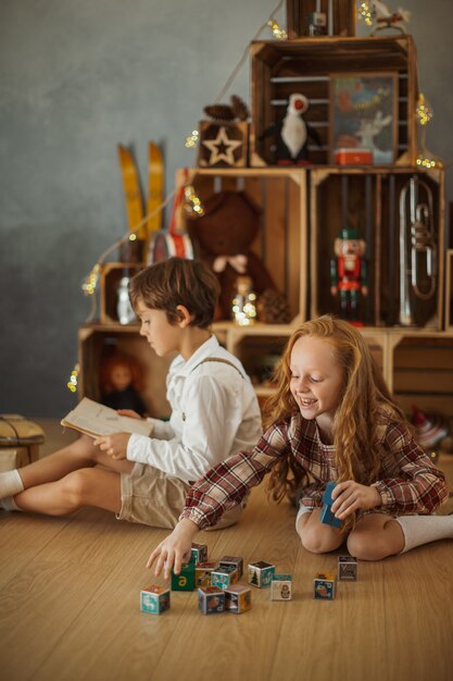 Two Kids Playing at Home during Winter Holidays