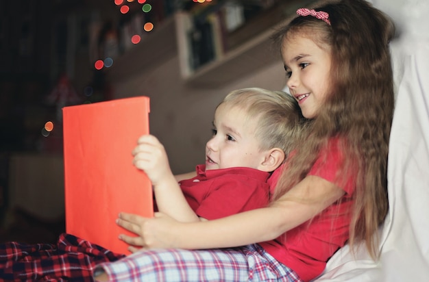 Two kids reading a book