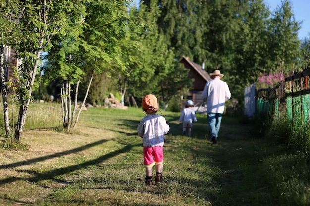 Two kids walk grandfather