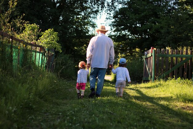 Two kids walk grandfather