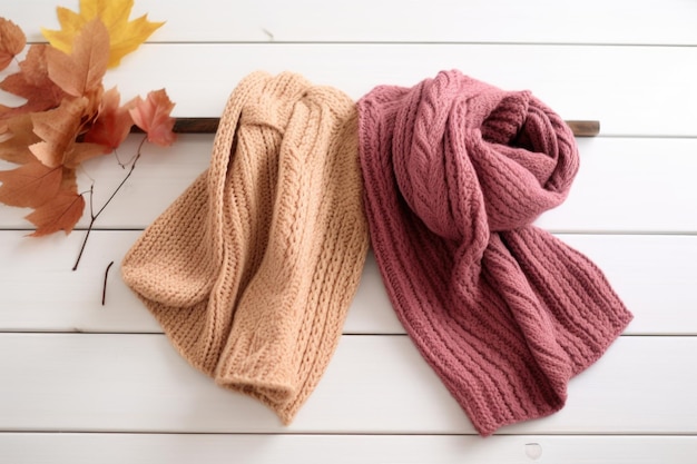 Two knit scarves intertwined lying on a white table