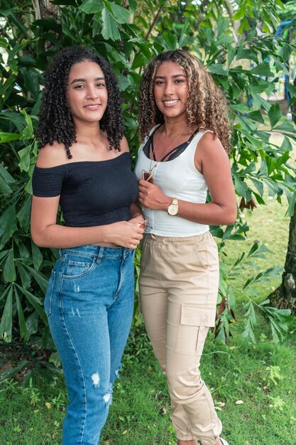 Two Latin friends standing in the city park