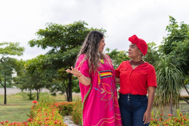 Two Latina women meet on the city street