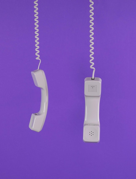 Two light retro handsets on a purple background Minimal concept