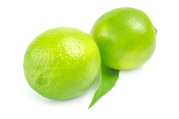 Two lime with leaf isolated on white