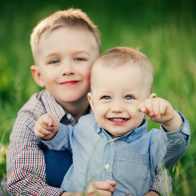 Two little brother embracing and looking