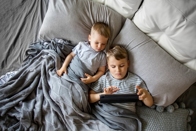 Two little brothers lying in bed