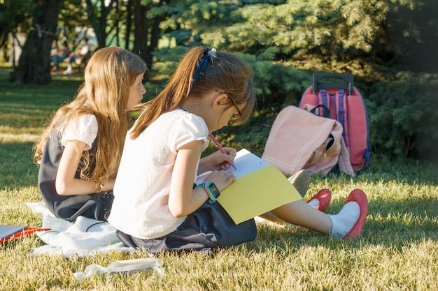 Two little girl friends schoolgirl learning