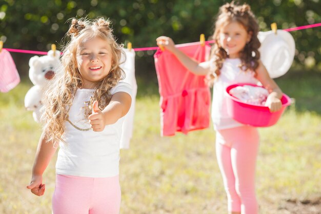 Two little girls laundring. Sisters doing housework