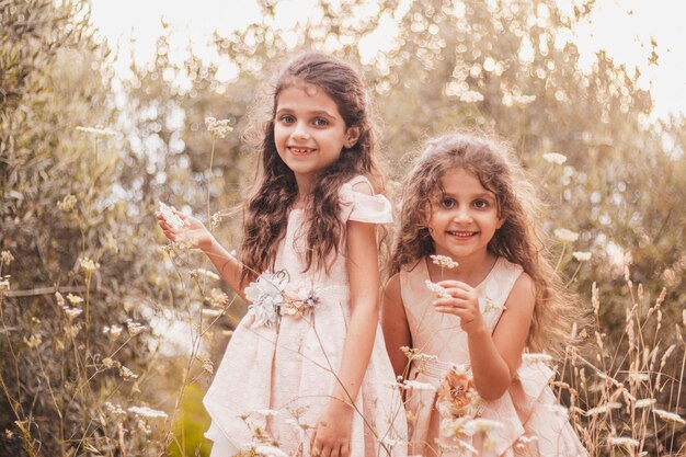 Two little girls playing in nature