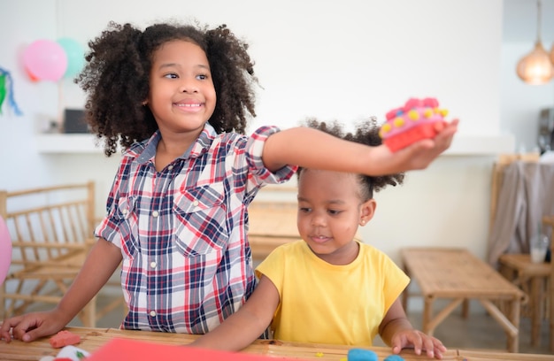 Two little girls Playing with plasticine