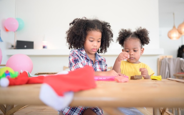 Two little girls Playing with plasticine