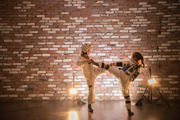 Two little girls training their karate skills attack and defense