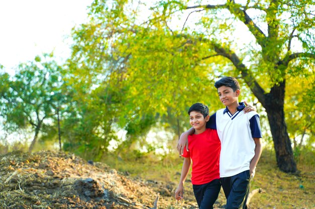 Two little indian brother walking on road
