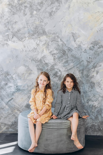 Two little sisters in studio