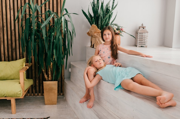 Two little stylish models girls posing 