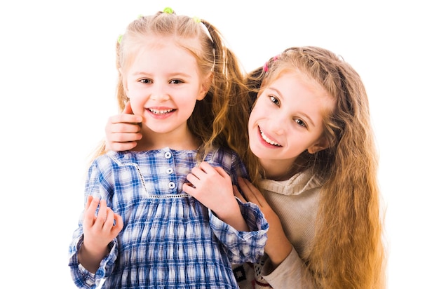 Two lovely happy girls playing and relaxing together isolated on white background two friends