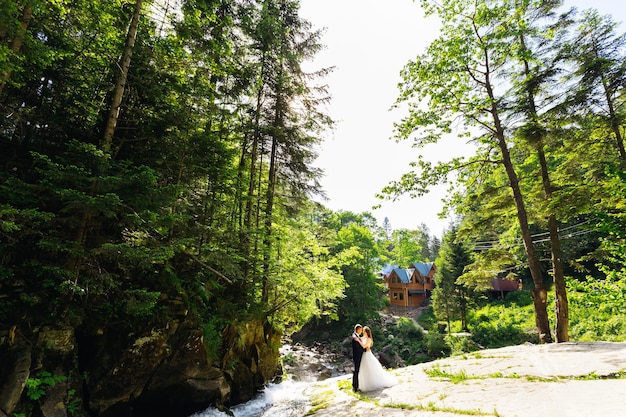 Two lovers embracing on top of a hill overlooking the city and river Romantic setting