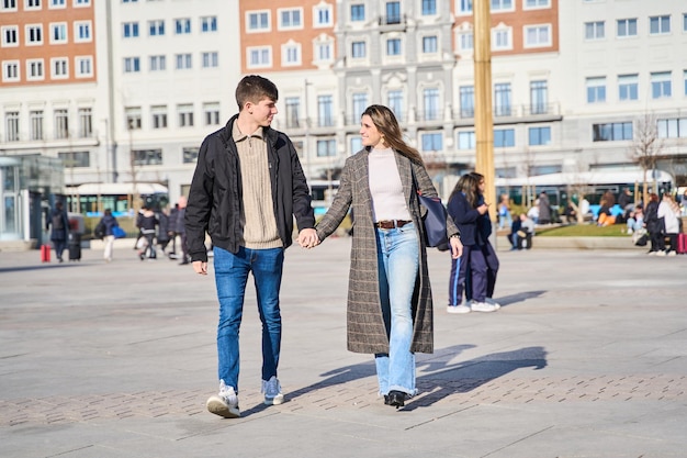 two lovers walking hand in hand through the city