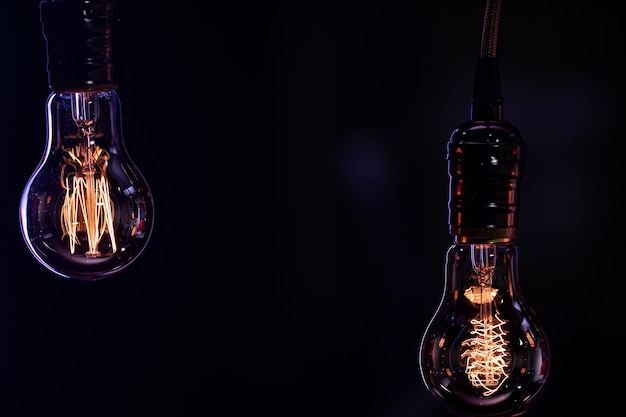 Two luminous lamps hang in the dark. Decor and atmosphere concept.