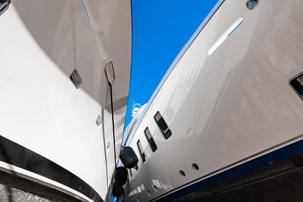 Two luxury motor yachts huddled together on fenders