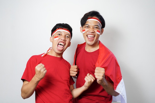 Two malaysian men wearing red shirts and holding a flag