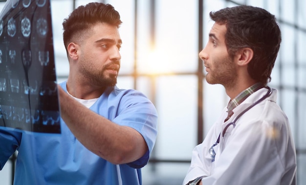 Two male doctors looking at brain xray