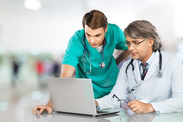 Two male doctors using laptop