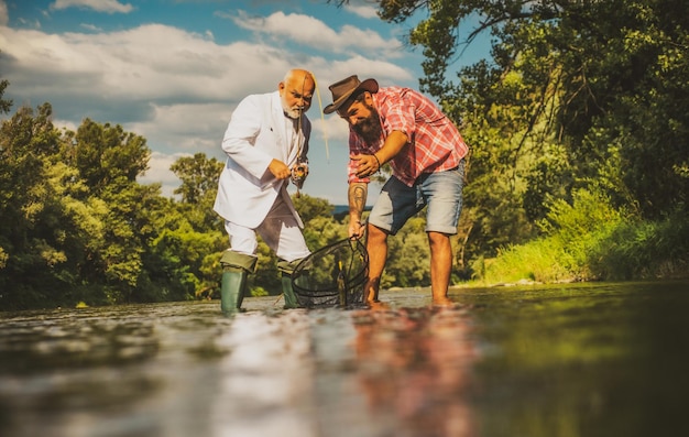 Two male friends fishing together fisherman with rod relax on nature cheers it is not sport it is ob