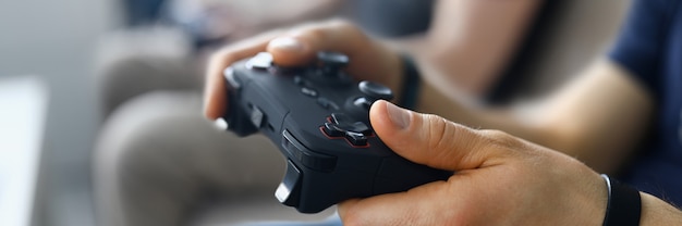 Photo two male friends play video games on home