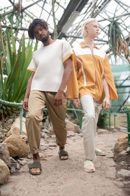 Two male models wearing summer clothes showing poses