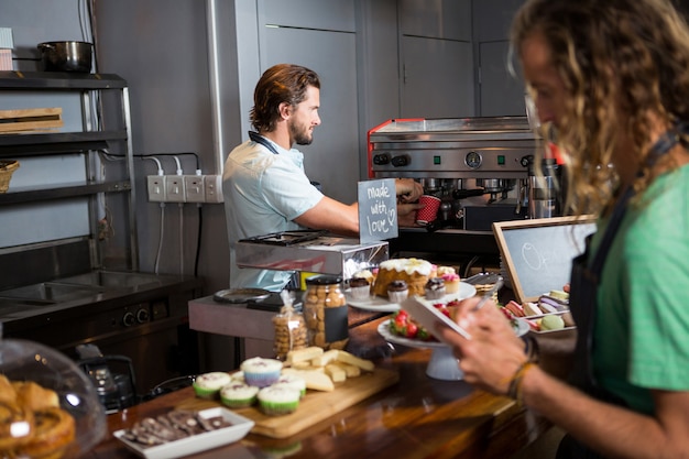 Two male staff working at counter