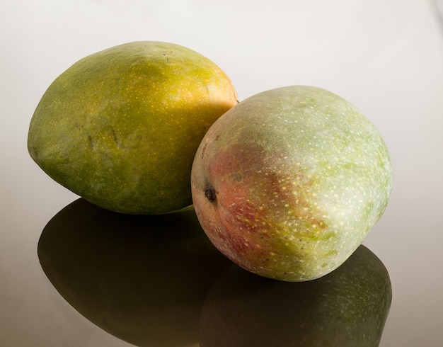 Two mangoes on reflecting surface