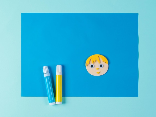 Two markers and an application of the little man's head on a blue background