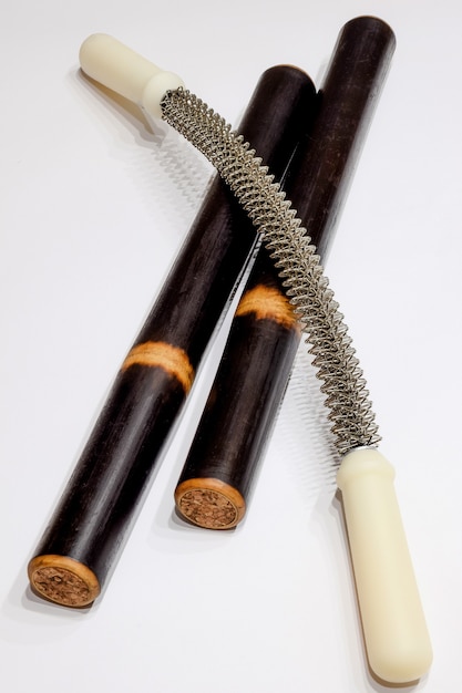Two massage sticks and massage equipment on a white background