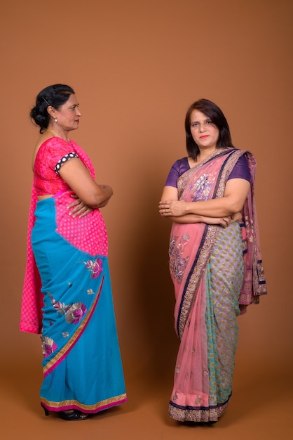 two mature Indian women wearing Sari Indian traditional clothes together 