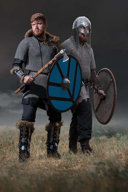 Two medieval warriors in full armor in armor historical concept