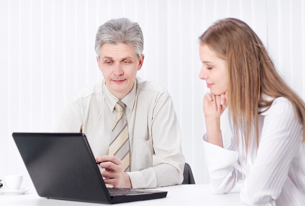 Two members of the company sitting behind a Desk in the office