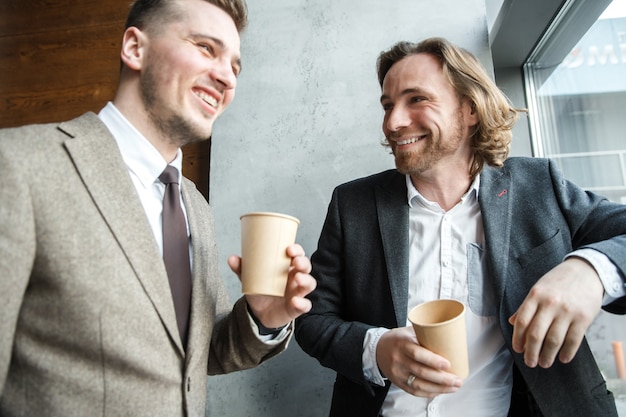 Two men are looking at each other and laughing