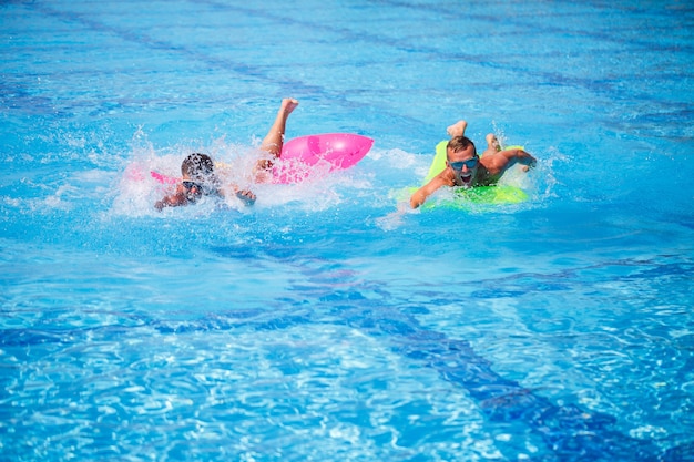 Two men bathe in the pool and relax