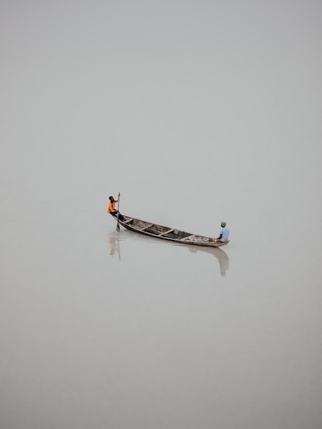 Two men on a boat with the word " o " on the side.