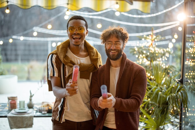 Two men celebrating winter holidays at backyard