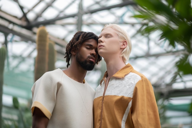 Two men closing eyes while enjoying time together