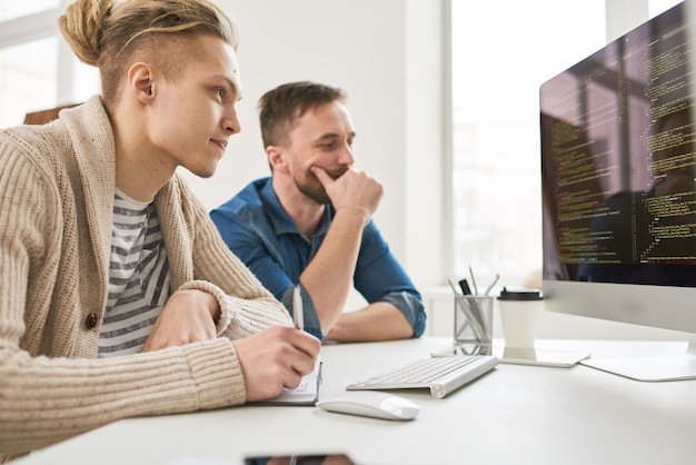 Two Men Collaborating on Code