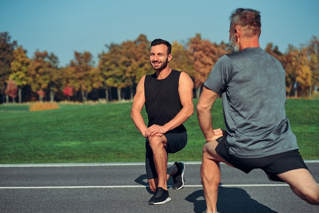 The two men doing exercise outdoor