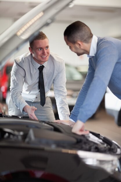 Two men looking at a car engine